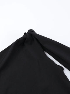 Black asymmetrical tied sleeveless maxi dress made of 100% polyester with no stretch and machine washable fabric.