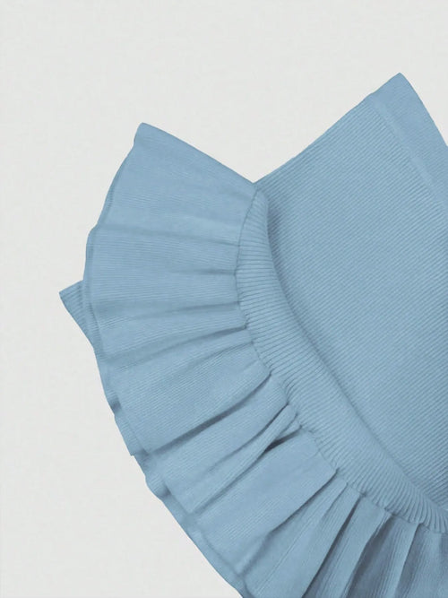 Close-up of light blue ribbed knit fabric with ruffled hem detail on bodycon dress