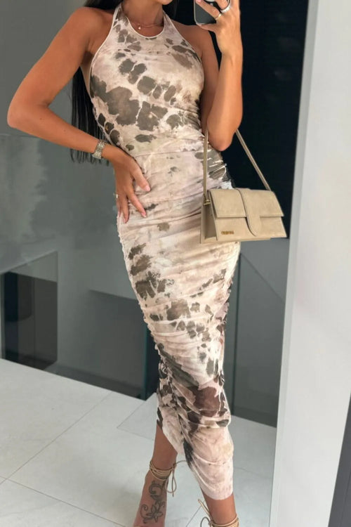 Backless printed halter neck dress in beige and brown shades.