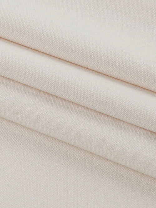 Close-up of beige polyester fabric for asymmetrical tied sleeveless maxi dress