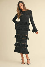 Long sleeve tiered ruffle knit midi dress in black with cutout and cable-knit details.