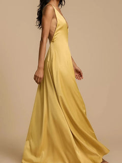 Yellow deep V-neck maxi dress with a backless crisscross design and slightly stretchy polyester fabric