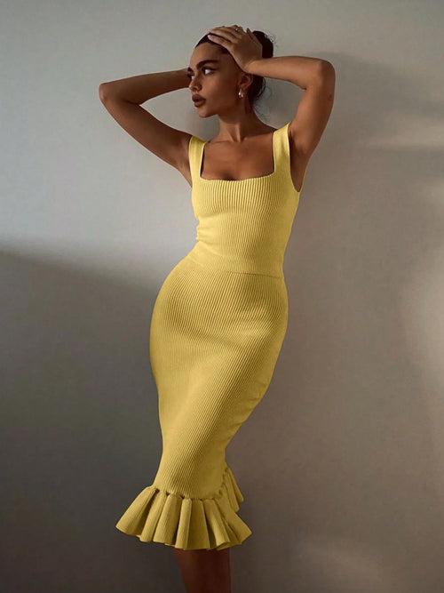 Woman wearing yellow ribbed knit bodycon dress with ruffle hem