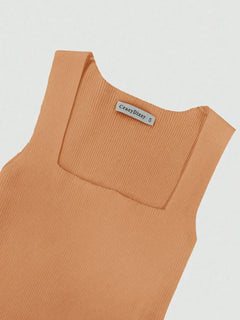 Close-up of ribbed knit bodycon dress in light brown with square neckline and sleeveless design