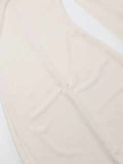 Beige asymmetrical tied sleeveless maxi dress made of 100% polyester with no stretch and machine wash care.