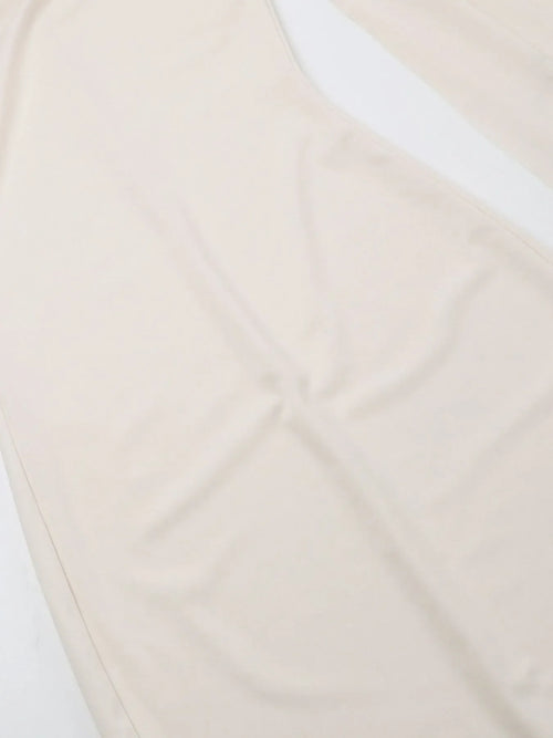 Beige asymmetrical tied sleeveless maxi dress made of 100% polyester with no stretch and machine wash care.