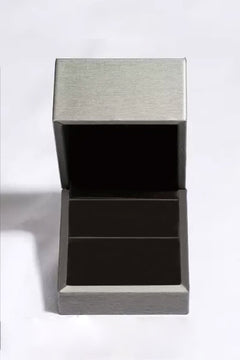Empty silver jewelry box open with black interior for moissanite teardrop earrings display