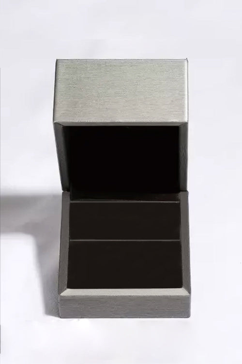 Empty silver jewelry box open with black interior for moissanite teardrop earrings display