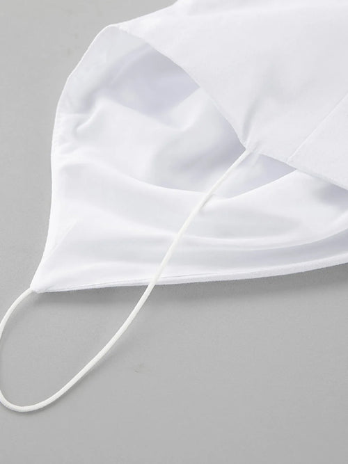 White cotton face mask with ear loops on gray background