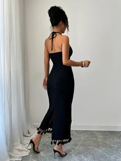 Black flower halter neck dress with tied back and tassel hem detail