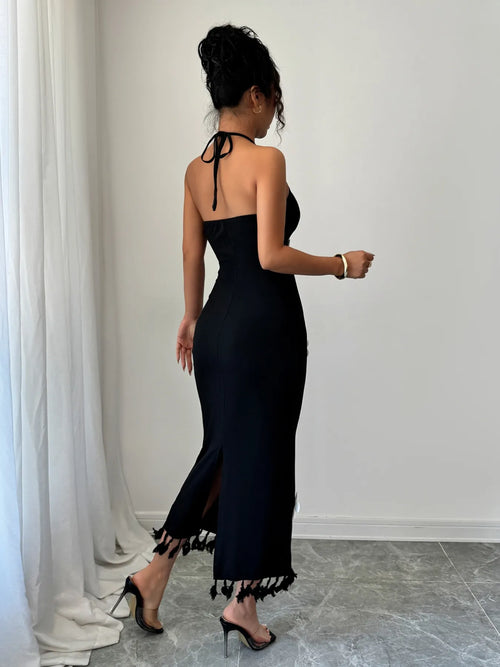 Black flower halter neck dress with tied back and tassel hem detail