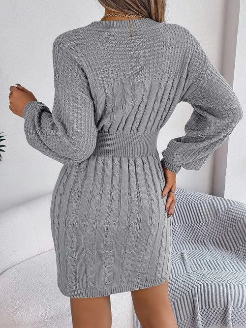 Gray cable-knit cutout slit sweater dress with long sleeves and round neck, featuring moderate stretch and fitted waist detail.