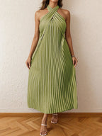 Green pleated halter neck midi dress with tied neckline and no stretch polyester fabric.