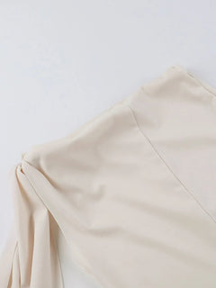 Close-up of a beige asymmetrical tied sleeveless maxi dress made of 100% polyester fabric