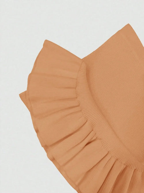 Close-up of ribbed knit bodycon dress in tan with ruffle hem detail