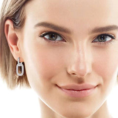 Close-up of a woman wearing 2.16 carat Moissanite 925 sterling silver earrings with 18K gold plating