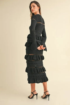 Long sleeve black knit midi dress with tiered ruffle design.