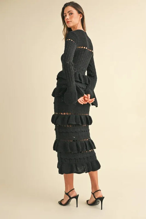 Long sleeve black knit midi dress with tiered ruffle design.