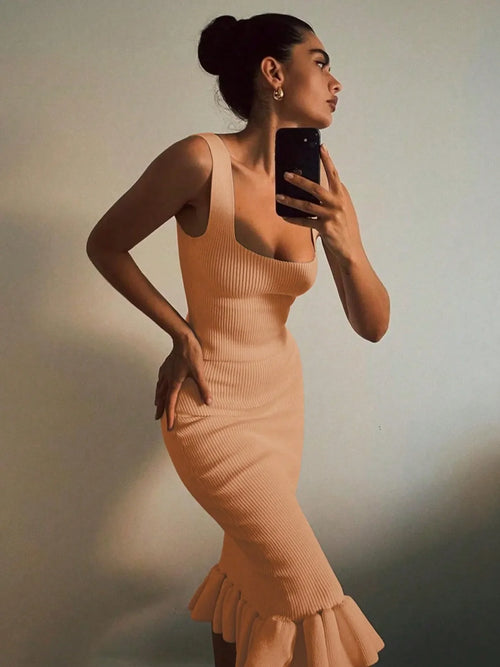 Ribbed knit bodycon dress with sleeveless design and ruffle hem in beige color
