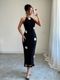 Black flower halter neck dress with white floral accents and a tied neckline