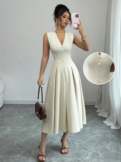 Woman wearing a white V-neck sleeveless midi dress with front button details and pleated skirt