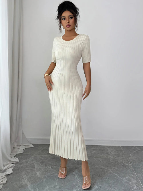 Woman wearing white ribbed round neck short sleeve sweater dress with moderate stretch reaching mid-calf