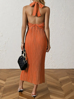 Orange pleated halter neck midi dress with tied back detail and sleeveless design