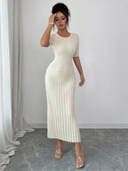 Woman wearing a white ribbed round neck short sleeve sweater dress with moderate stretch, midi length, and fitted silhouette