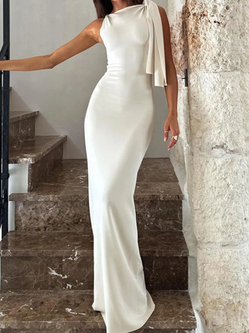 White asymmetrical tied sleeveless maxi dress made of 100% polyester with a fitted silhouette and no stretch.