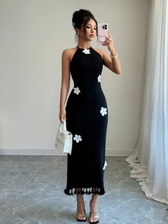 Black flower halter neck dress with white floral accents and tied neckline