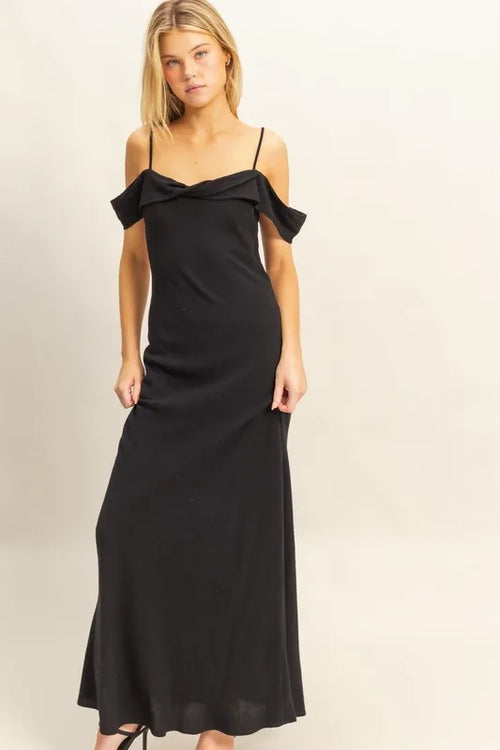 Woman wearing a black HYFVE Flattering Fit Cami Maxi Dress with ruffled asymmetrical neckline and slim silhouette.