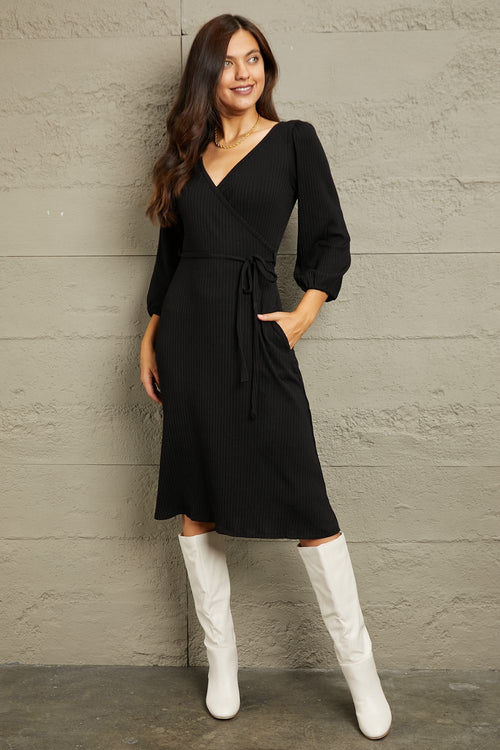 Culture Code Full Size black surplice flare midi dress with ruching sleeves and waist tie worn with white boots