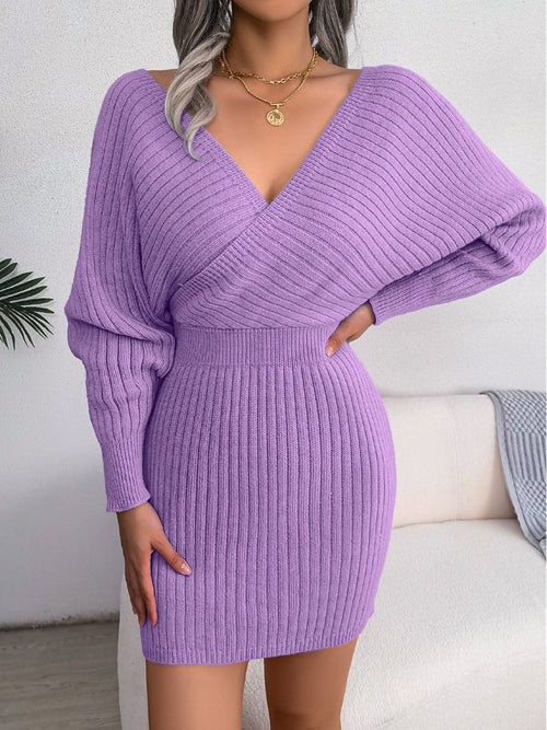 Purple rib-knit dolman sleeve sweater dress with surplice neckline and a-line mini length, featuring long ribbed sleeves and moderate stretch.